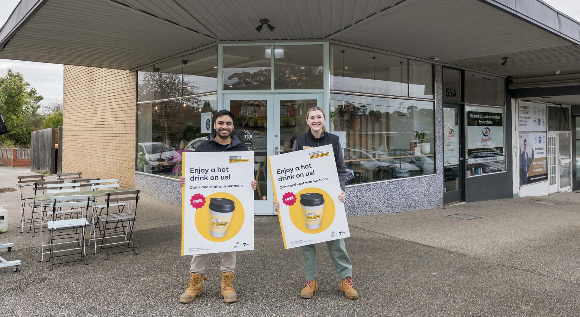 Two big build staff outside cafe pop up