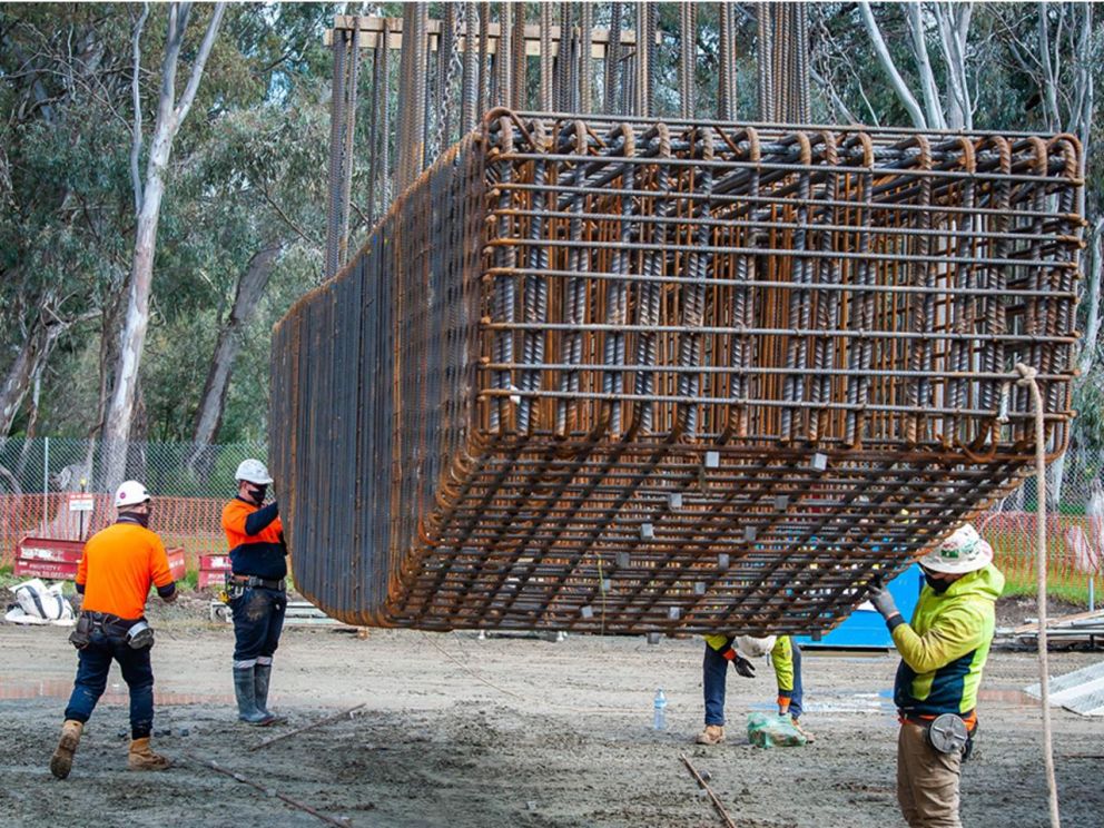 Image of the headstock steel reinforcement process with construction workers assisting with the process