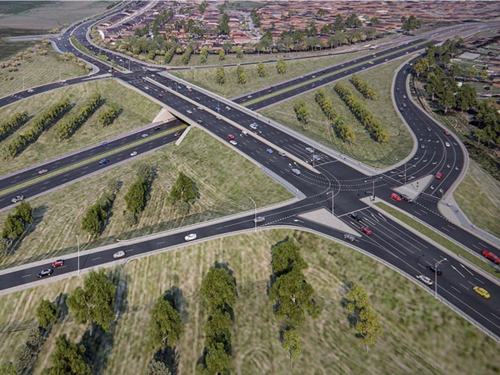 Artist impression of the upgraded Beaconsfield interchange. Image shows overlapping roads with bare land in between and housing in the distance