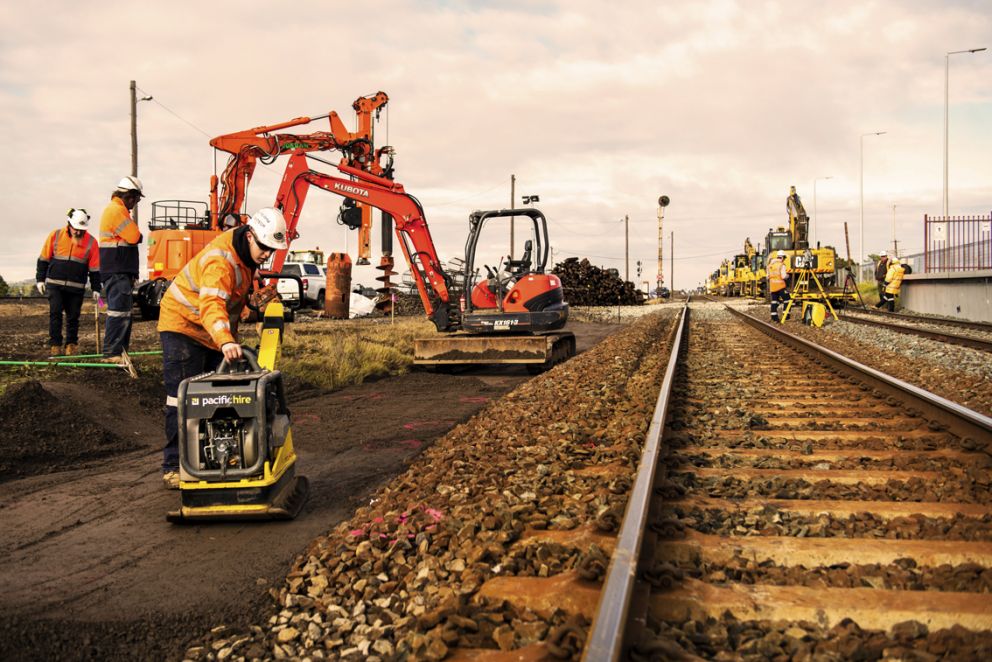 Construction workers using small and large equipment to carry out platform extension works