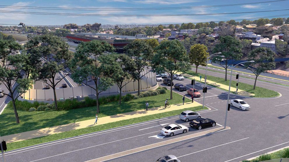 Artist impression of Watsonia with the train station car park in the background. In the foreground pedestrians and cyclists are utilising the footpath on a land bridge and traffic is travelling on the road. 