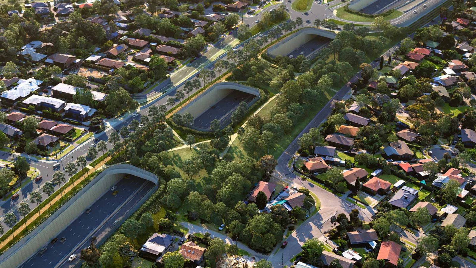 An aerial concept design of a land bridge over a lowered North East Link in Watsonia, surrounded by buildings and houses.