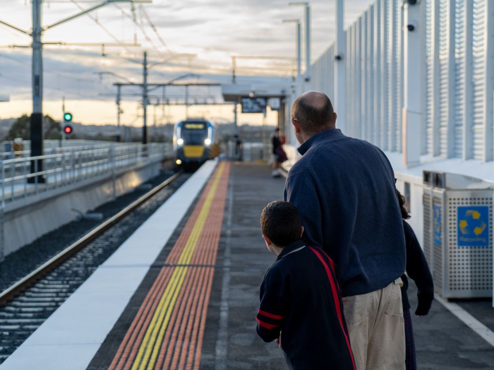 A man and young boy waiting at the new Hallam Station