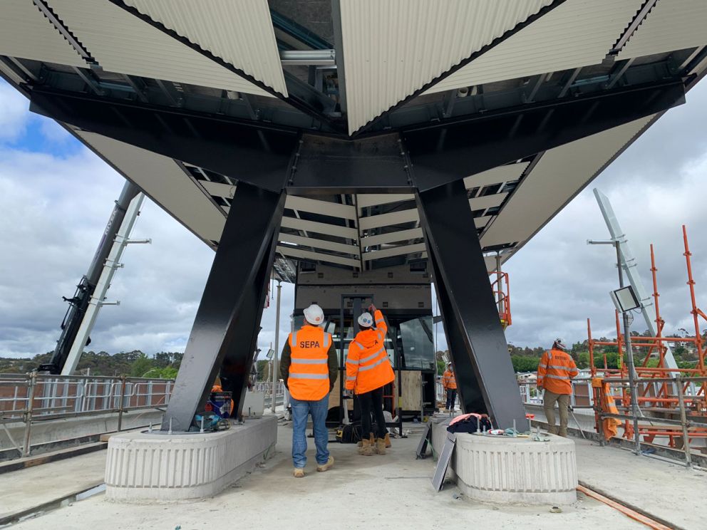 Workers at station canopy.