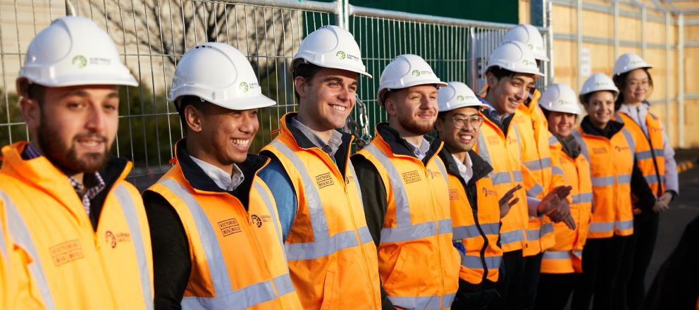 Grads standing in line on construction site