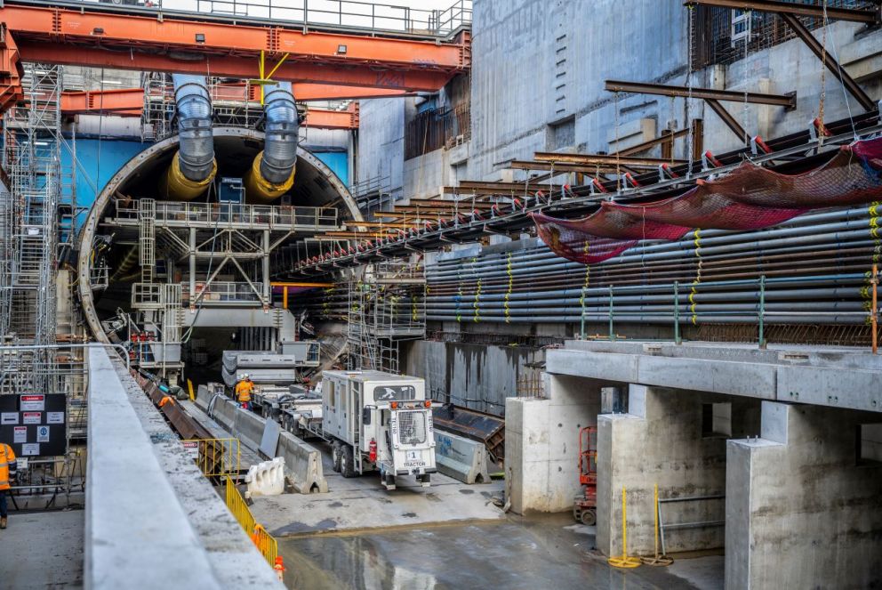 Tractor carrying concrete segments parked at the tunnel entrance.