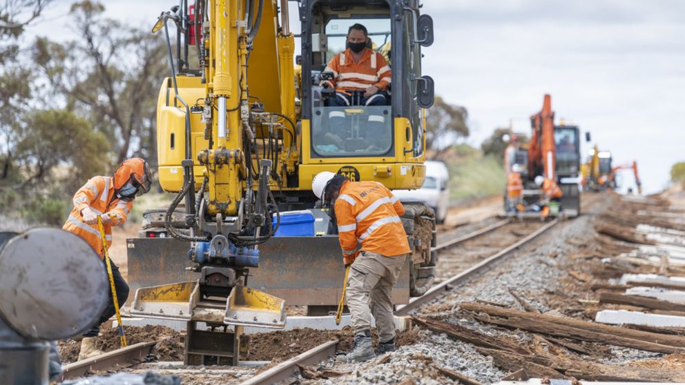 Workers and machinery replacing wooden sleepers on the Murray Basin Rail project 