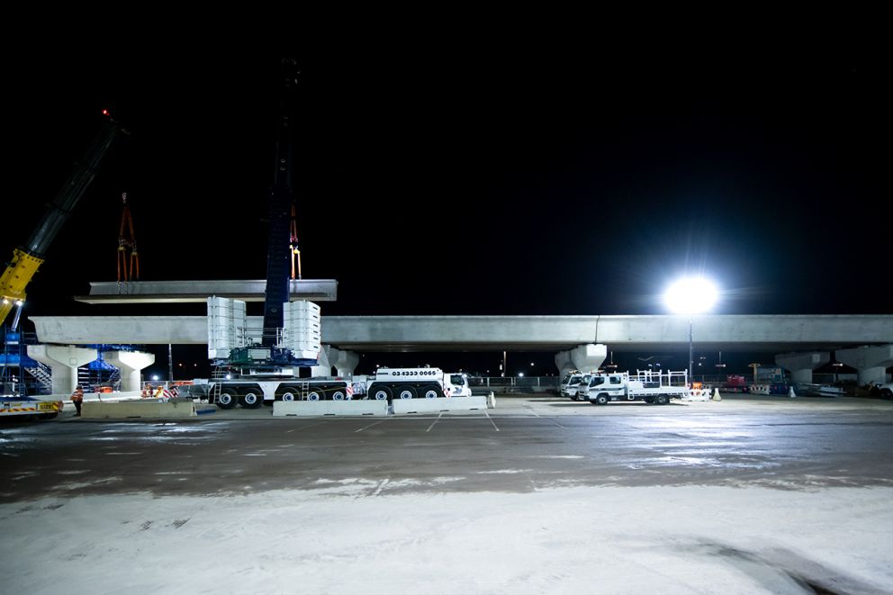 The December works saw 28 beams lifted into place, with another 32 to arrive in early 2023 as the new rail bridge takes shape over Mt Derrimut Road