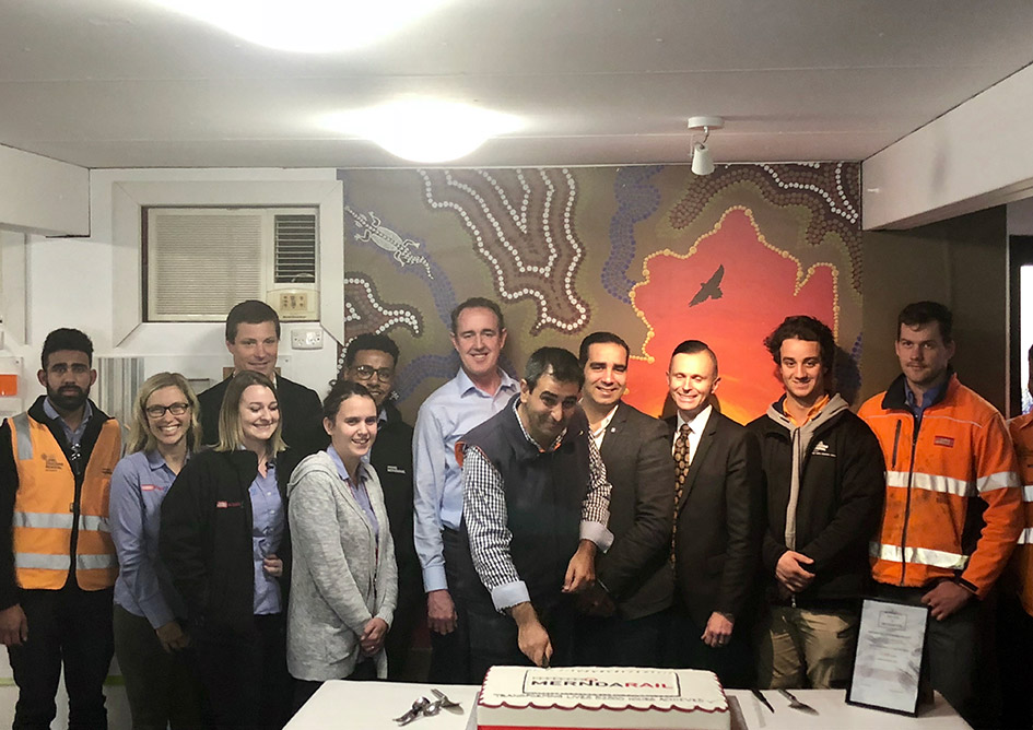Group eating a cake to celebrate win