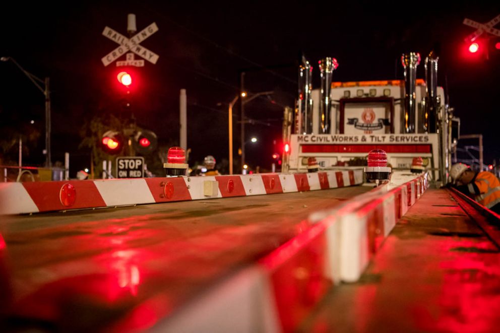 The removed boom gates from Reservoir level crossing being driven away on a truck