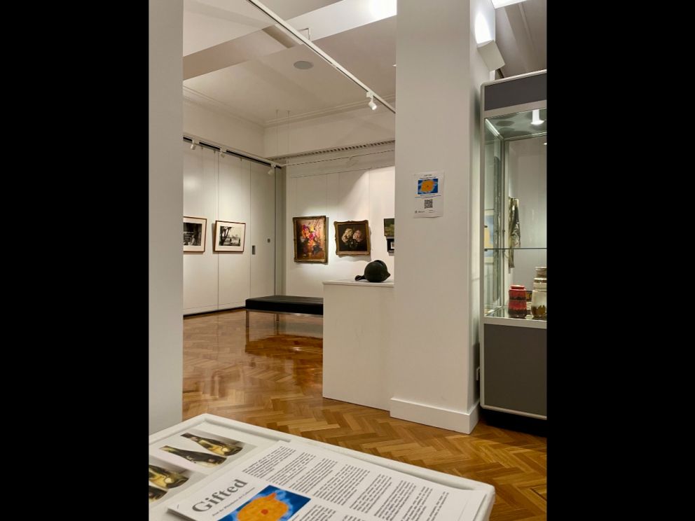 Art gallery room with many art pieces hanging on the walls