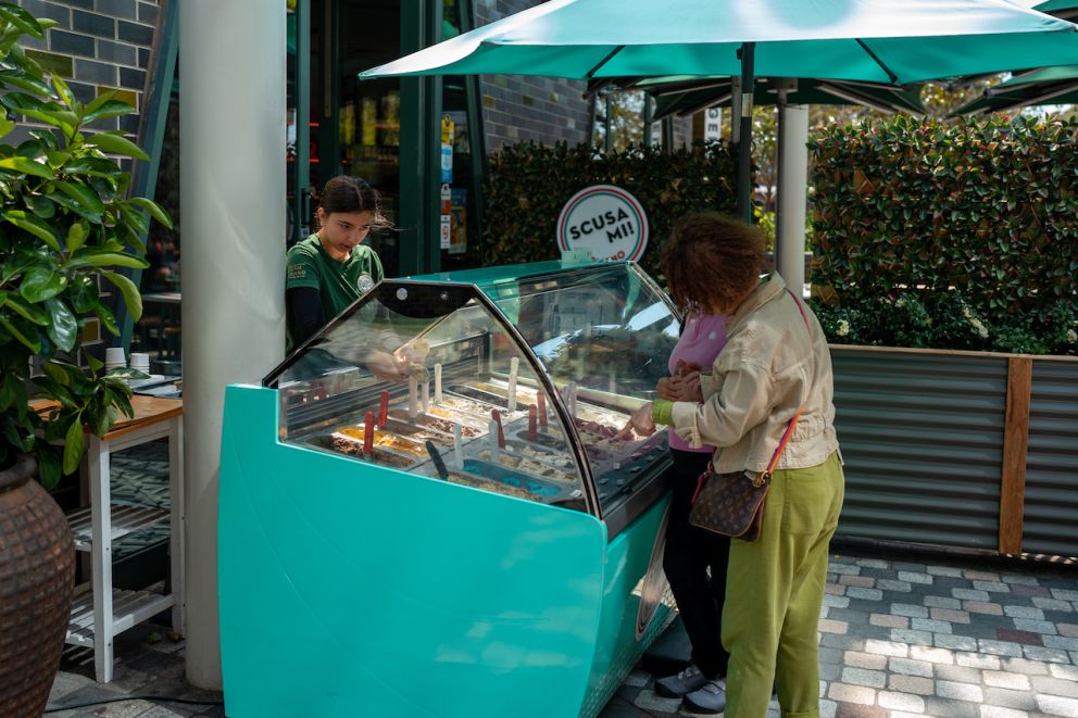 Worker serves icecream to customer at Scusa Mi restaurant