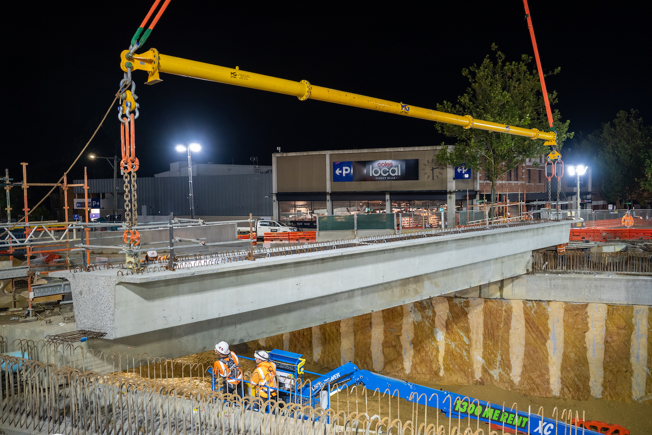 One of the road-bridge beams being installed over Union Road