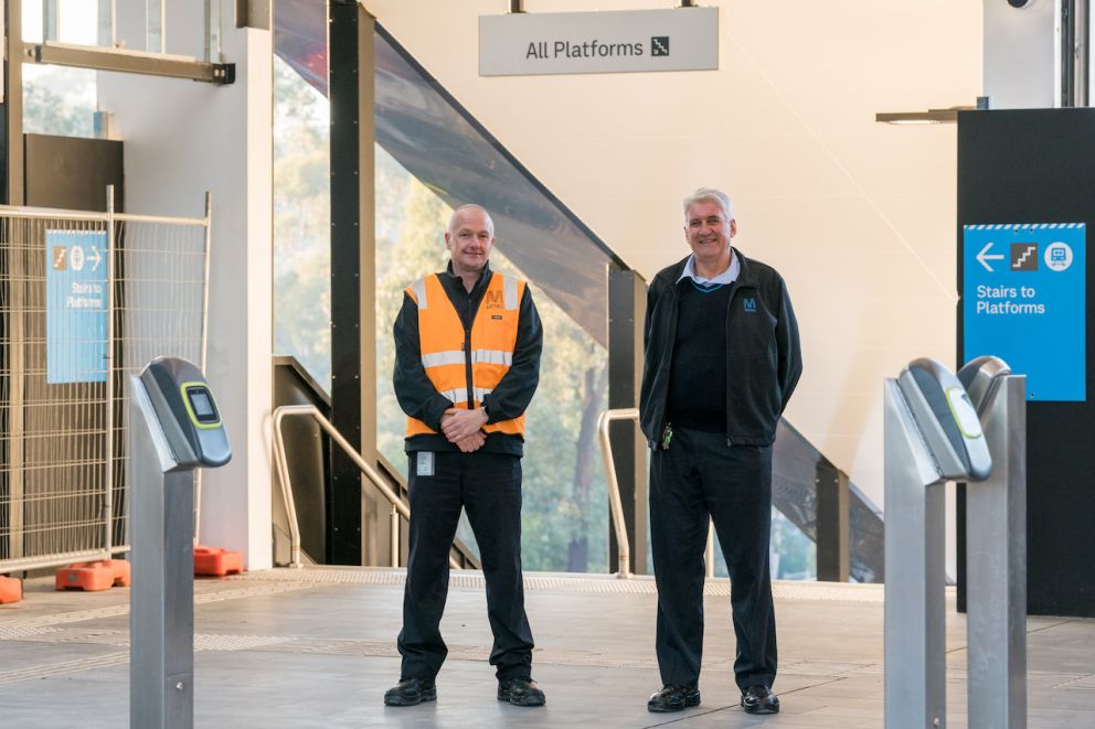 Staff welcome passengers to the new Greensborough Station