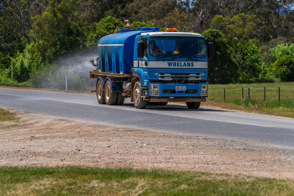 A water truck helps minimise dust along haulage route