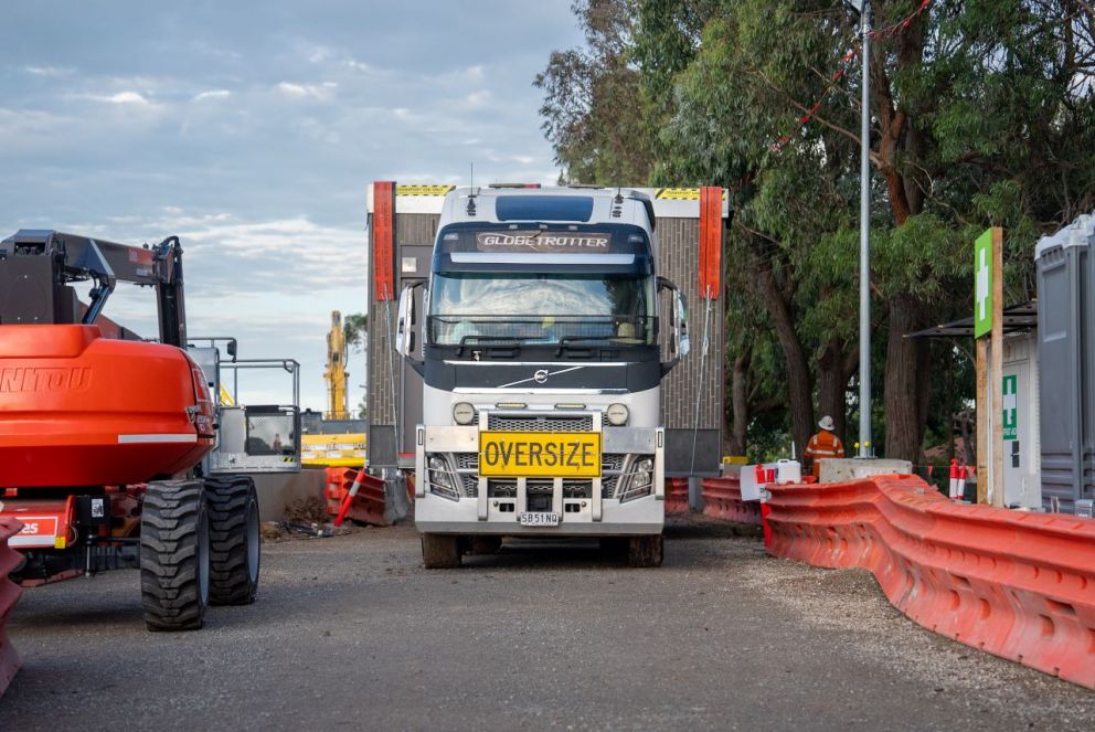 Truck delivers modular station buildings into site
