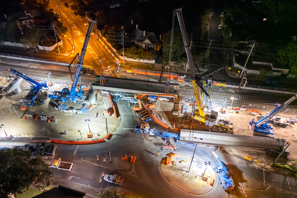 Cranes lifting L-beams over Warrigal Road at night