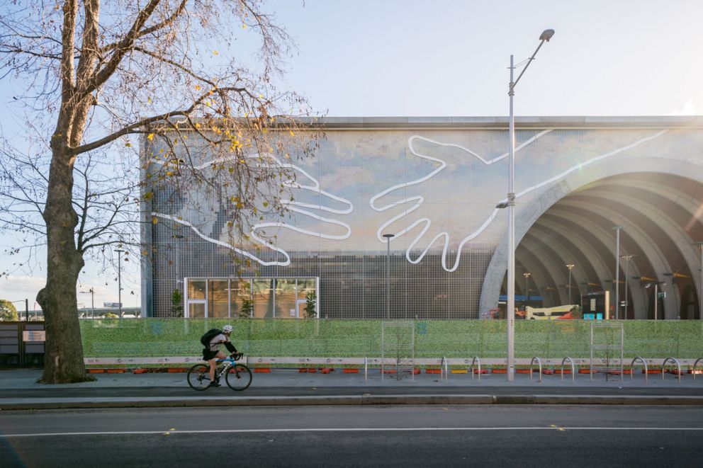 A wide shot of Arden featuring a biker staring at Abdul Abdullah's 'Come Together' artwork. 