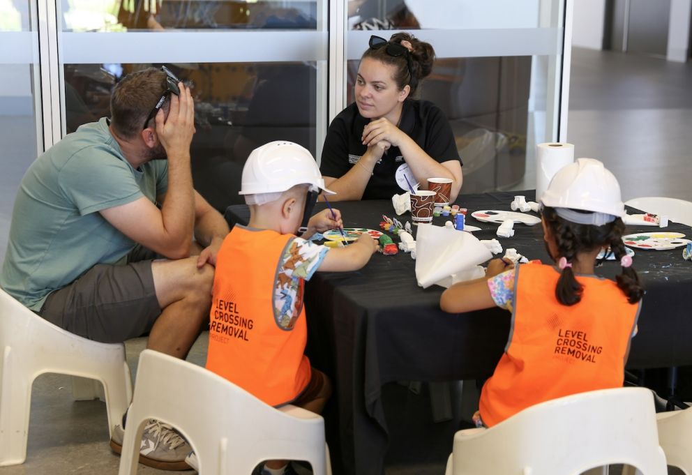 Kids painting miniature construction equipment