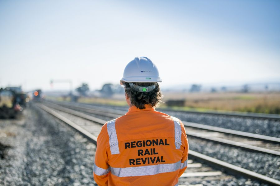 A Regional Rail Revival worker looking towards the train tracks on the Shepparton Line