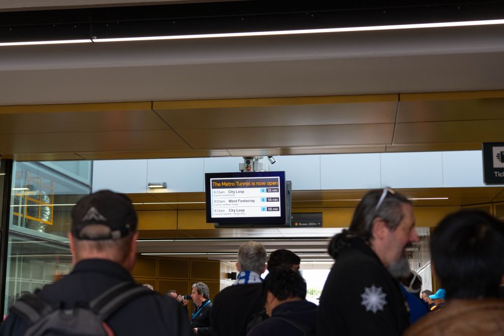 Passengers wait for the first train services. 