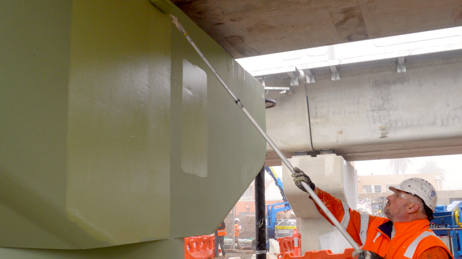 Worker painting the Mordialloc Station piers