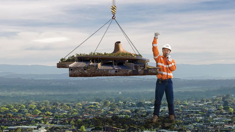 A giant construction worker lowering road into place