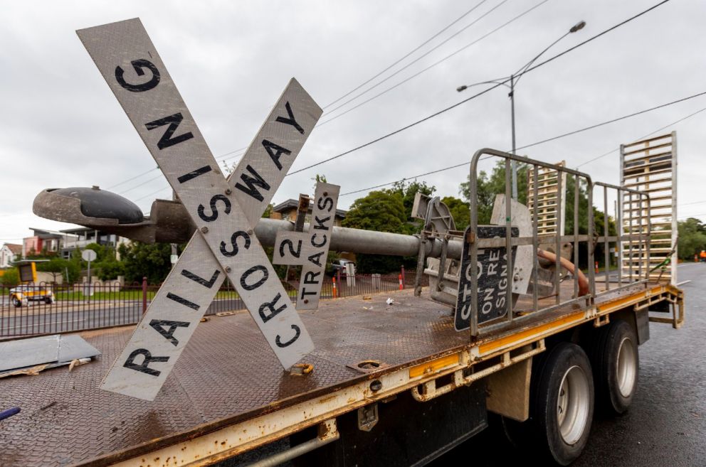 A truck carrying the old railway crossing sign.