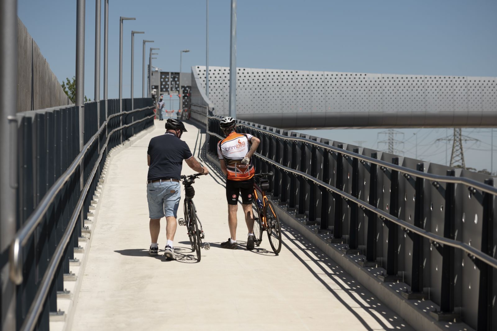 2 cyclists using the new Rosala Avenue pedestrian bridge ramp