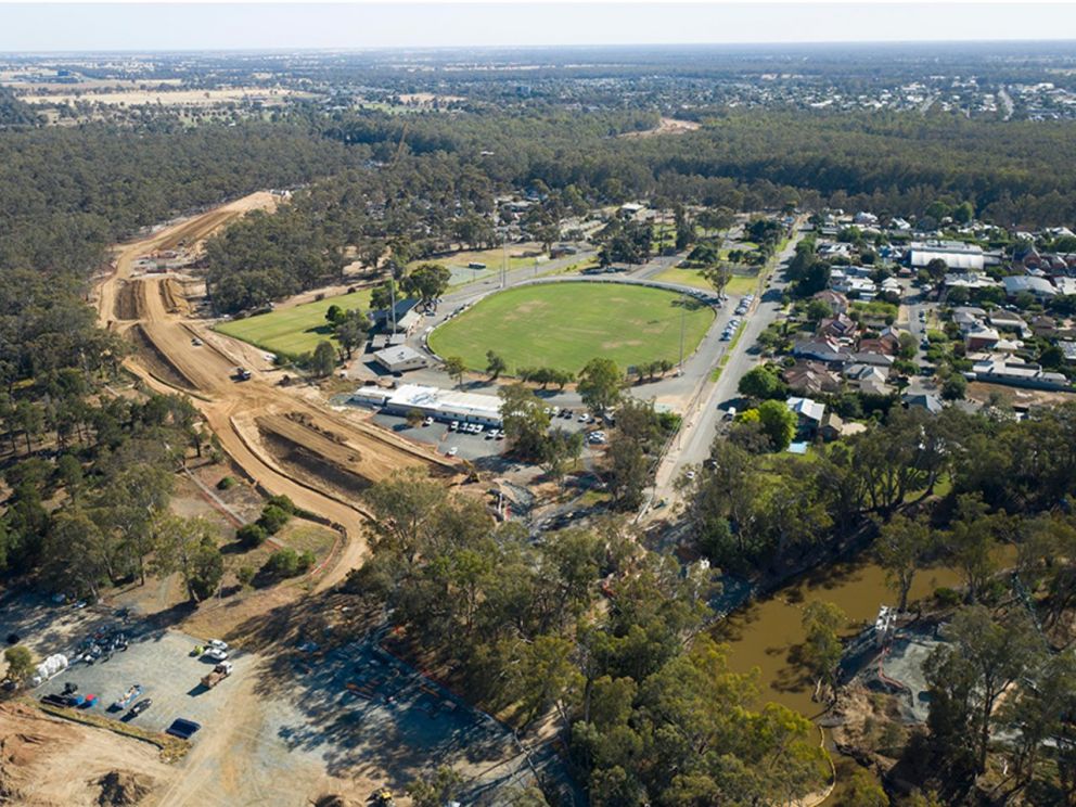 Birds eye image of road construction with the local sporting precinct behind it as well as housing