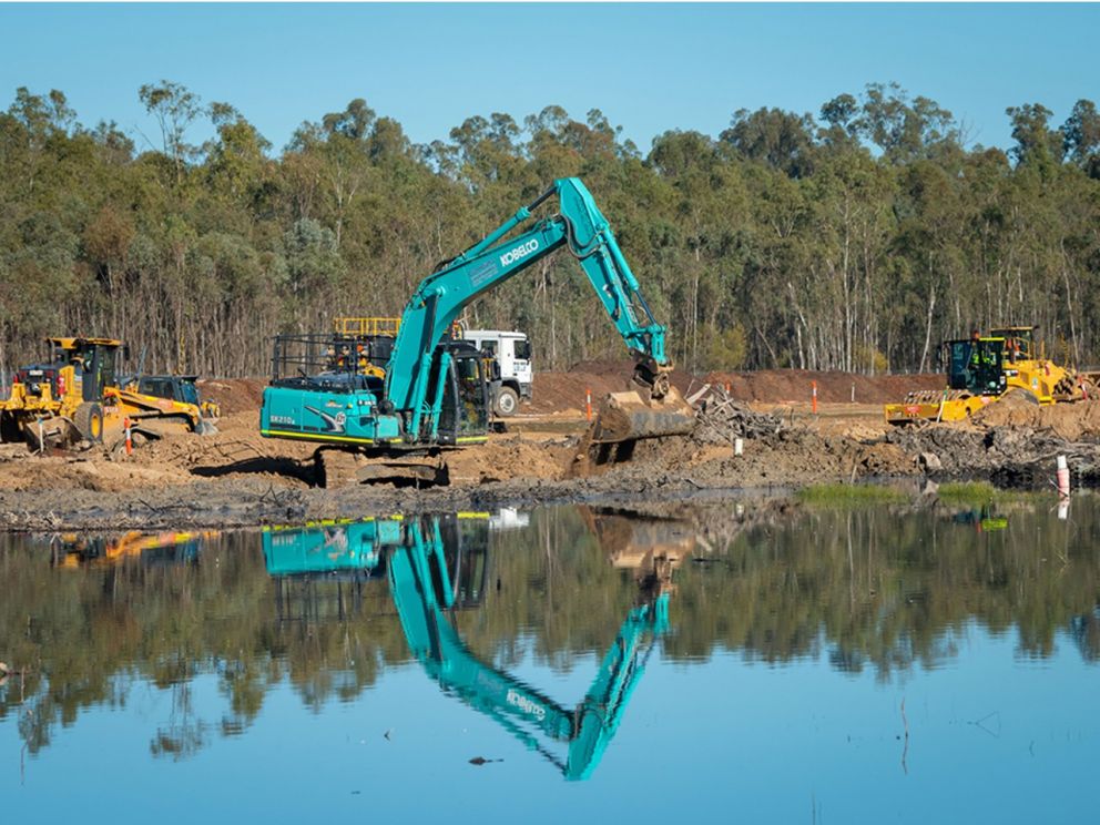 Image of excavators working on site with a river flowing in front