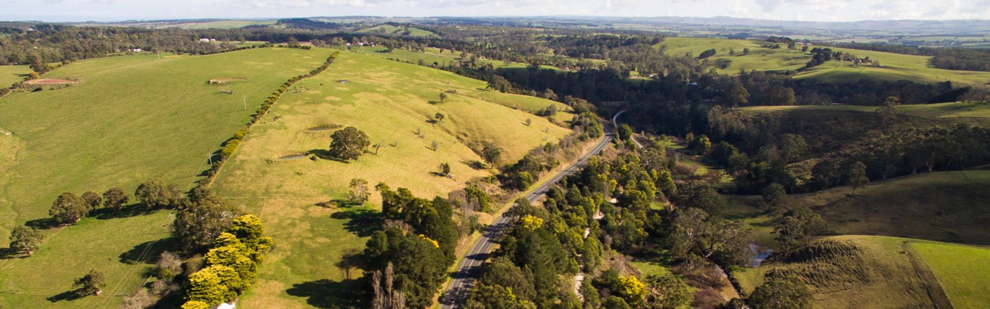 Aerial view of the South Gippsland Highway surrounded by green landscape