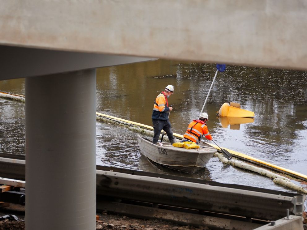 Beginning removal of the temporary working platform under the 400-metre twin bridges over the Waterways wetlands