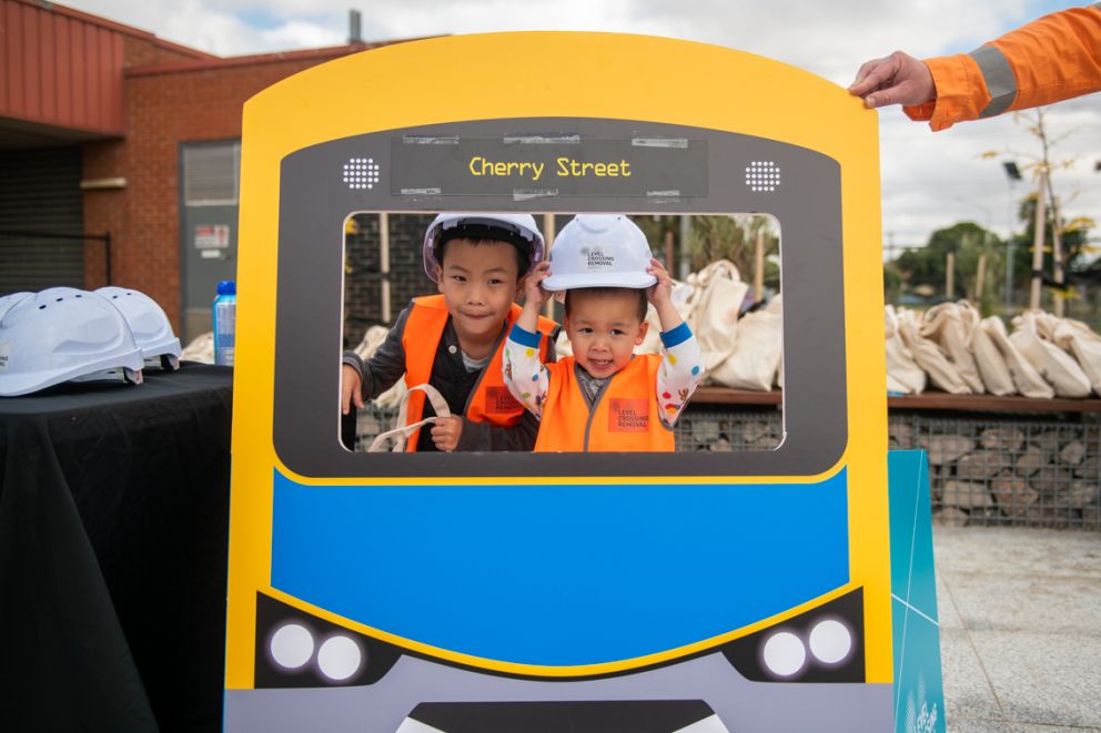 Kids dress up in Level Crossing Removal Project PPE.