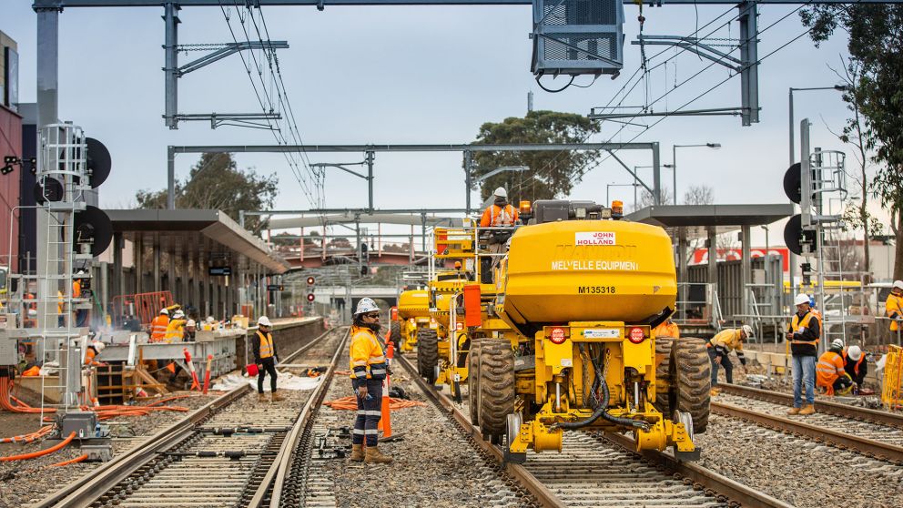 Workers working on an outdoor rail line