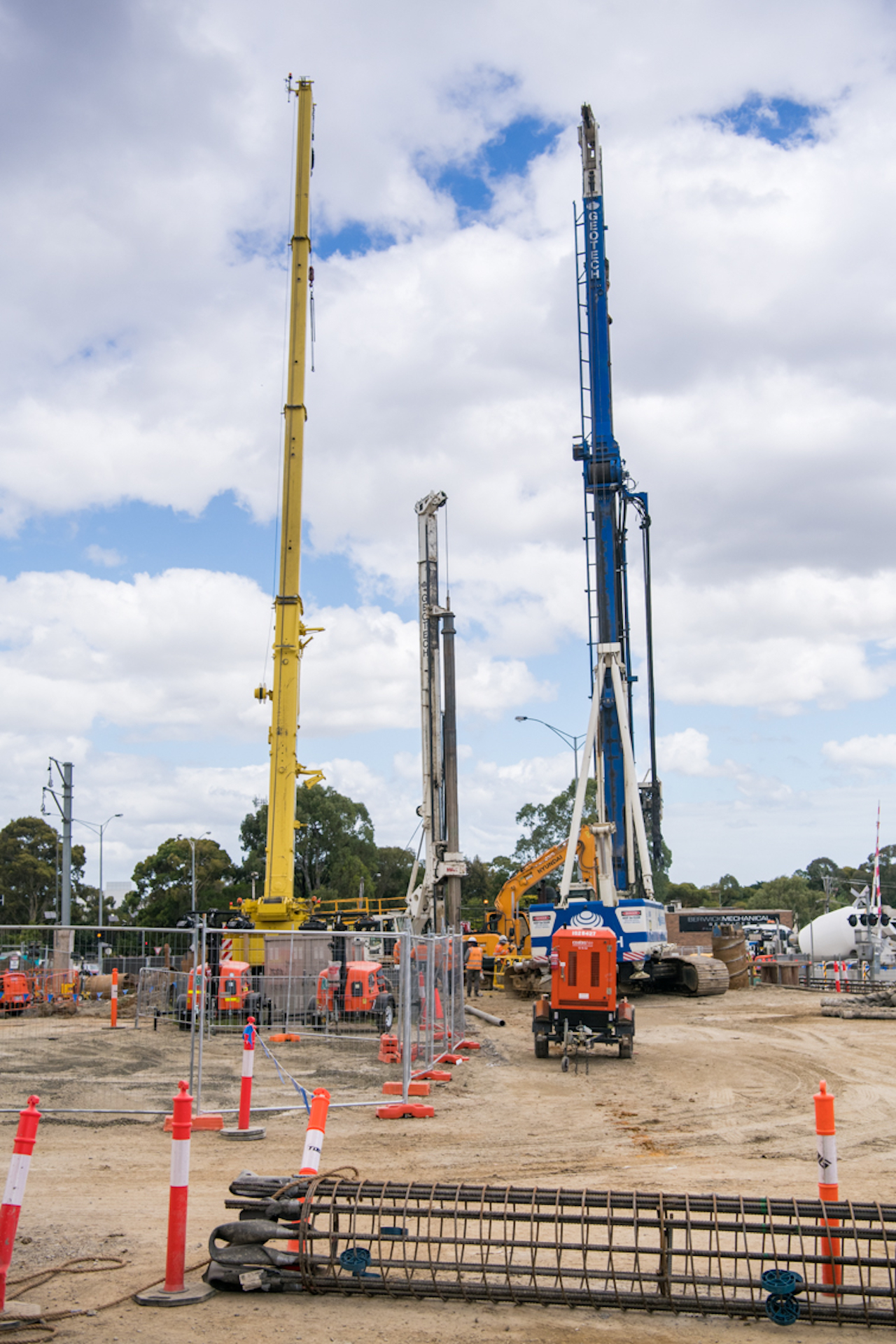 2 tall piling rig machines next to each other on site