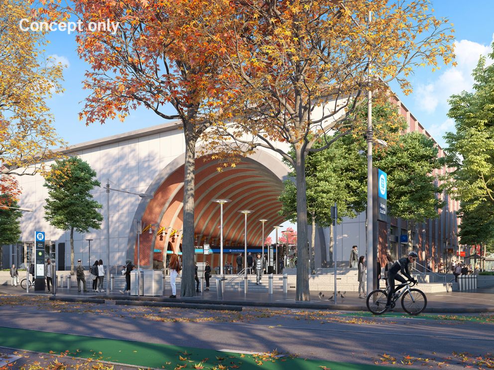Render of Arden Station main entrance exterior with a road in front and scattered trees