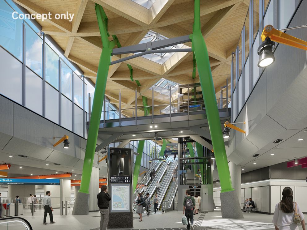 A render of Anzac Station interior with the escalators and walls of windows in view. Skylights and roofing are supported by big green pole foundations.