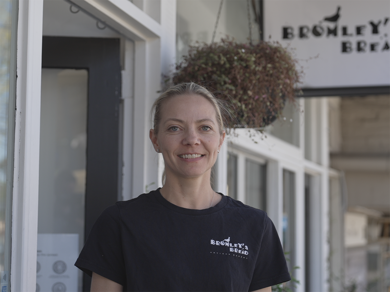 Owner of Bromley\'s Bread, Jenny standing in front of her shop front