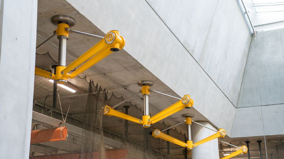 Four yellow metal structures to hold lights in the station.