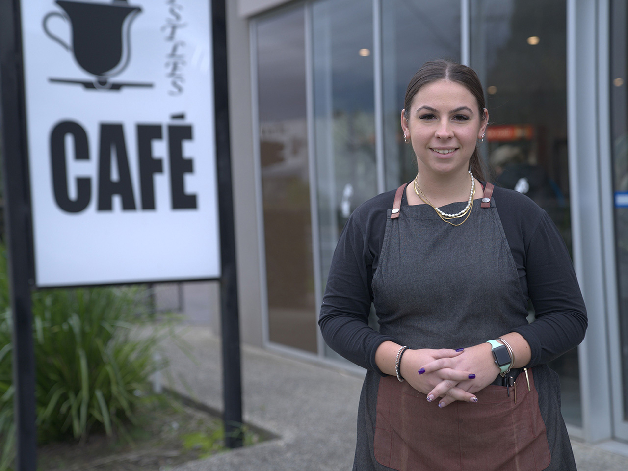 Image of owner Scarlett outside her cafe, Bells and Whistles Caf\u00e9