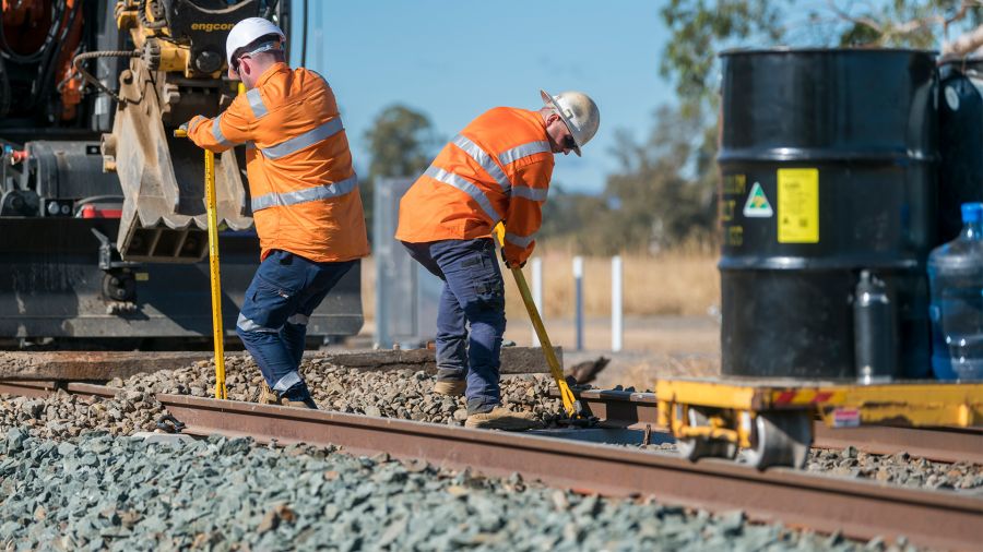 Two men  in hi-vis doing rerailing work on the Shepparton Line Upgrade. 