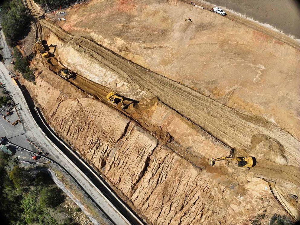 Excavators move and load material from the fourth and final landslip bench