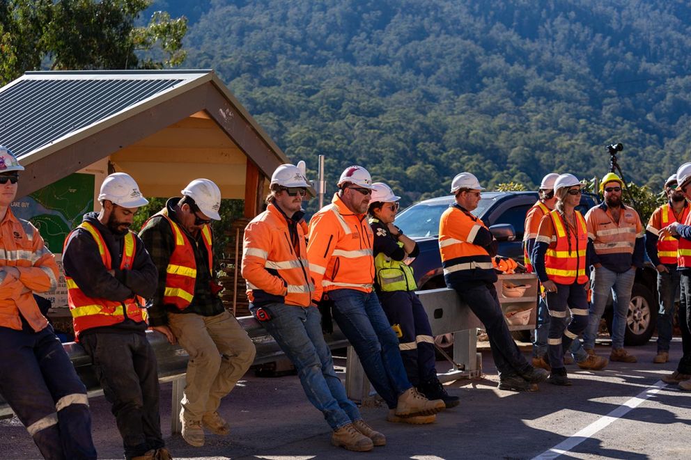 Crews gather for a pre-opening briefing session on Bogong High Pains Road near the entrance to Bogong Village