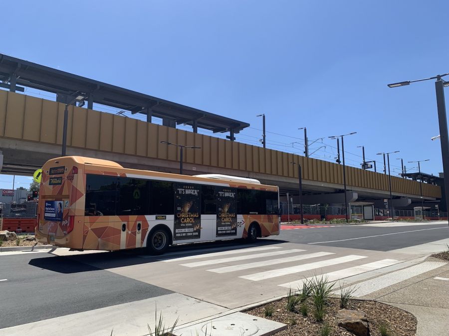 A bus passing the new elevated rail line