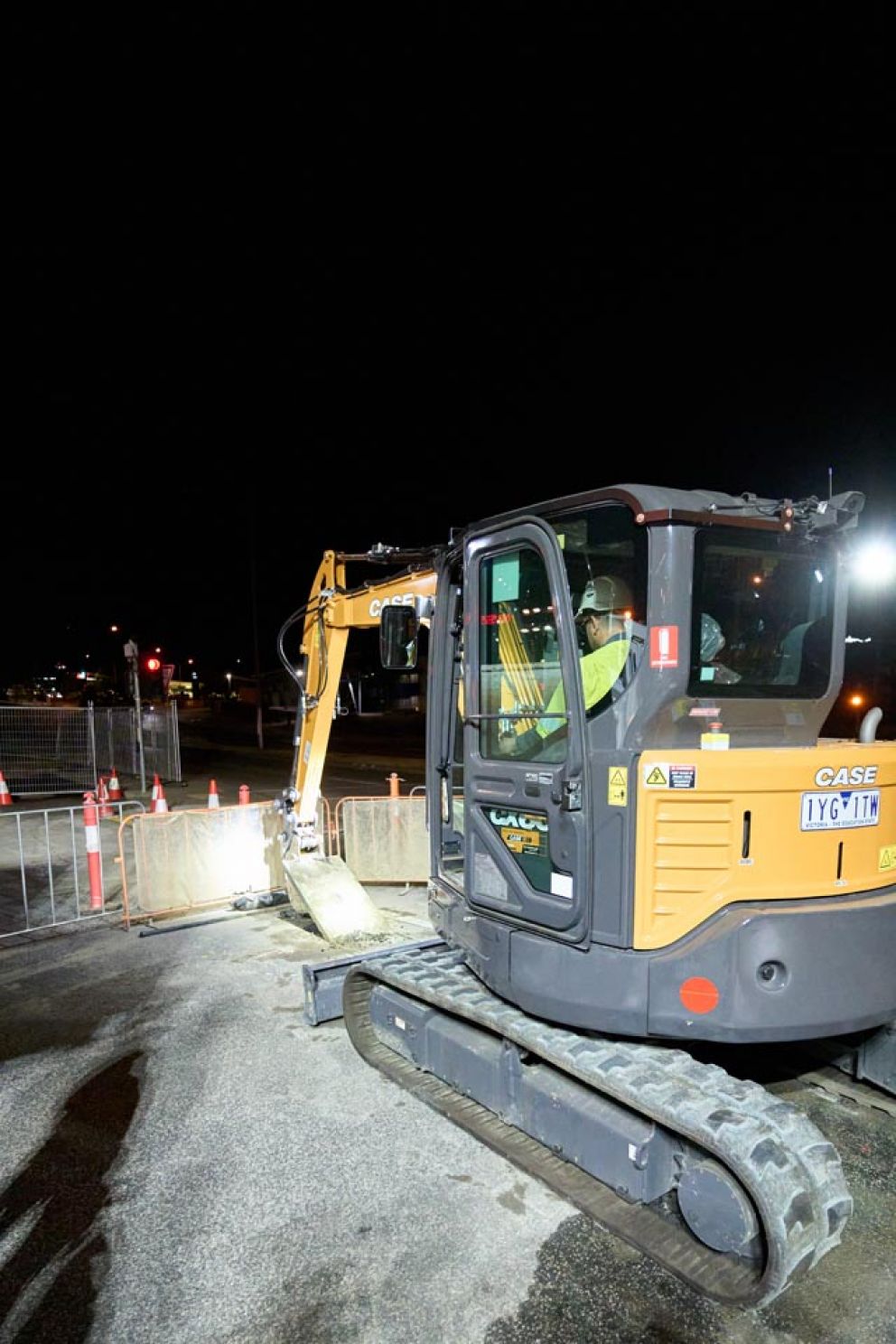 An excavator trenching for utility relocation