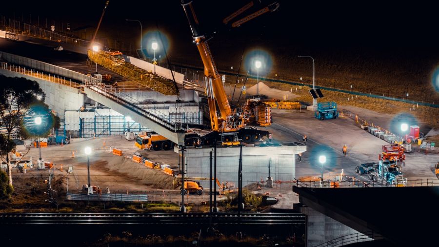 A crane carefully lifted the 9 concrete beams into place