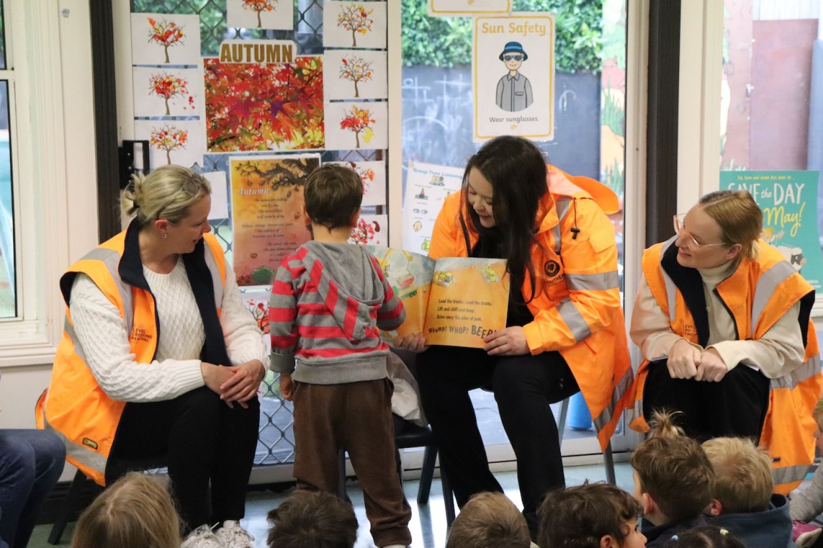 Level Crossing Removal Project staff reading The Little Yellow Digger to local children