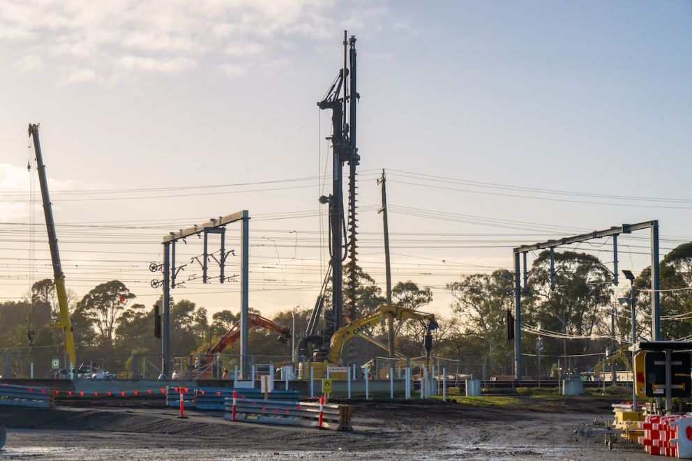 A pilling rig excavates a piles for overhead wiring posts where the rail line will be once works are completed