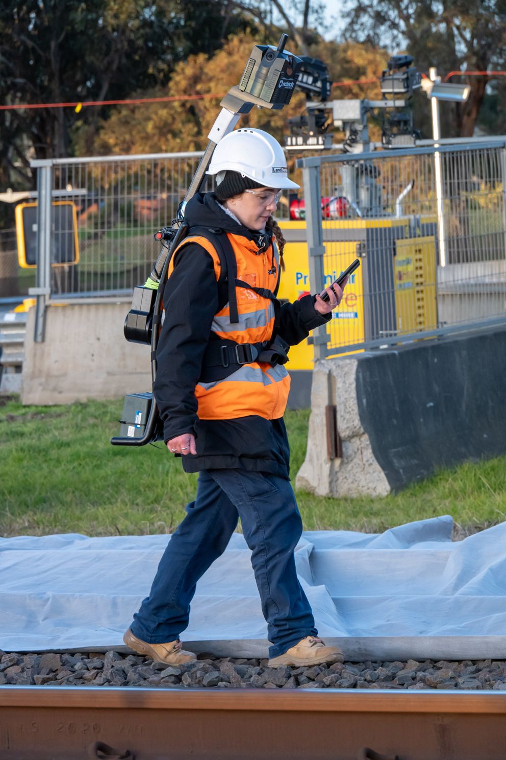 A surveyor captures and records spatial data along the rail corridor for the Webster Street level crossing removal